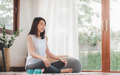 Asian woman doing yoga meditation at home Asian woman doing yoga meditation at home